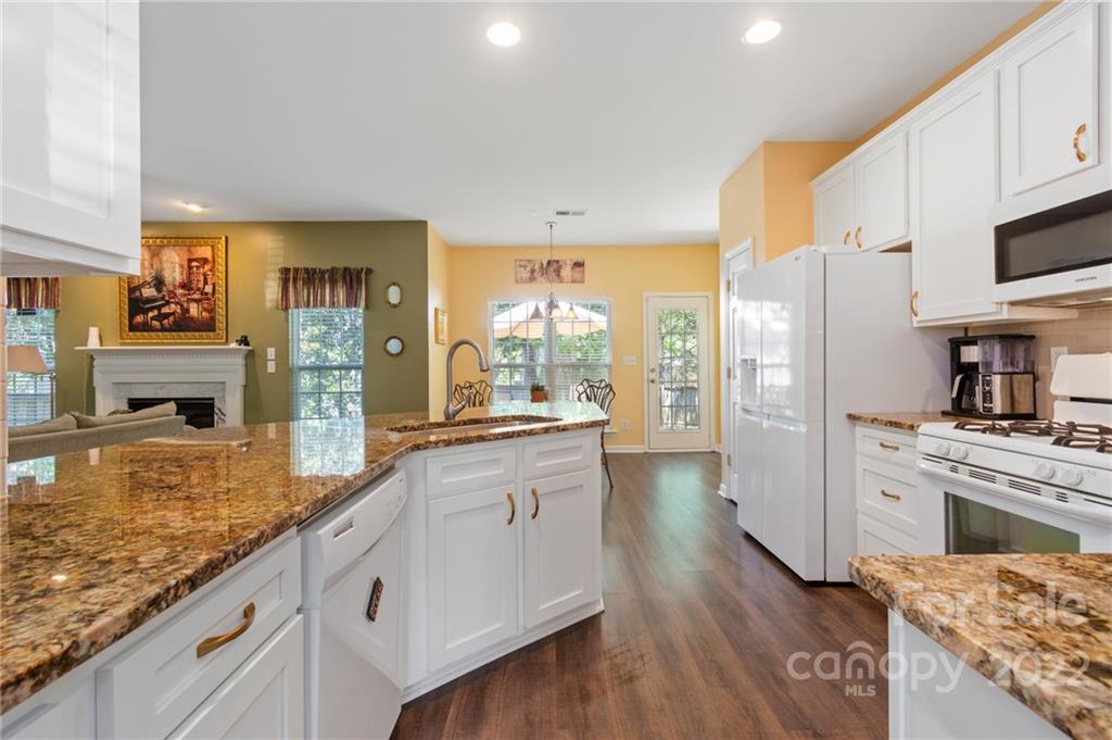4905 Missi Lane Fort Mill, SC 29708 - Photo 7 of 34 a large kitchen with cabinets wooden floor and stainless steel appliances