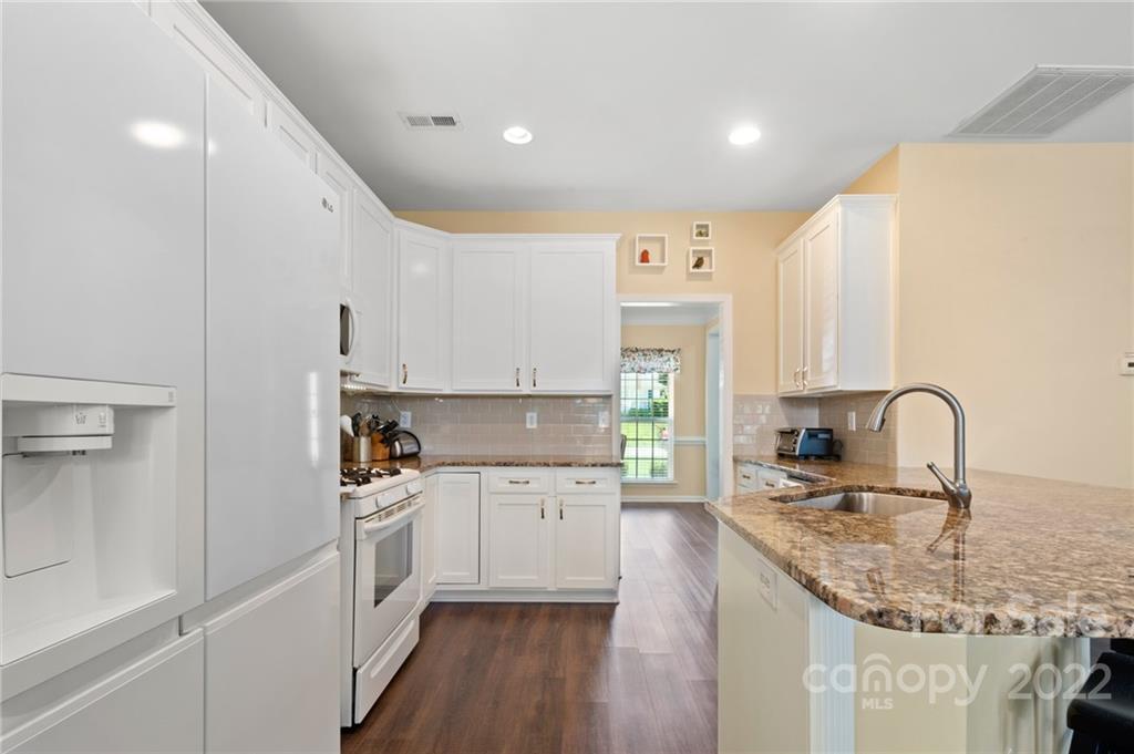 4905 Missi Lane Fort Mill, SC 29708 - Photo 8 of 34 a kitchen with granite countertop a sink stainless steel appliances and white cabinets