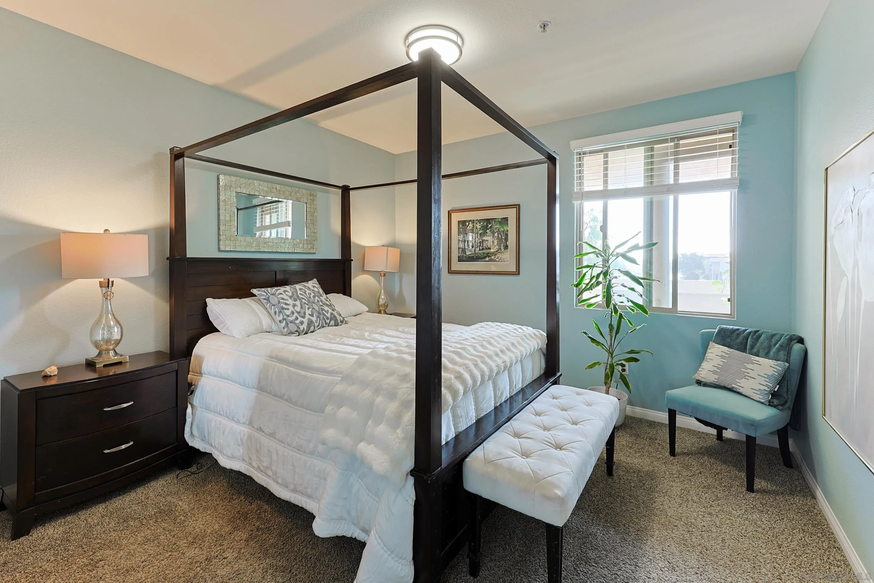 3887 Pell Place, Unit 229 San Diego, CA 92130 - Photo 11 of 49 a bedroom with a bed a couch and a window