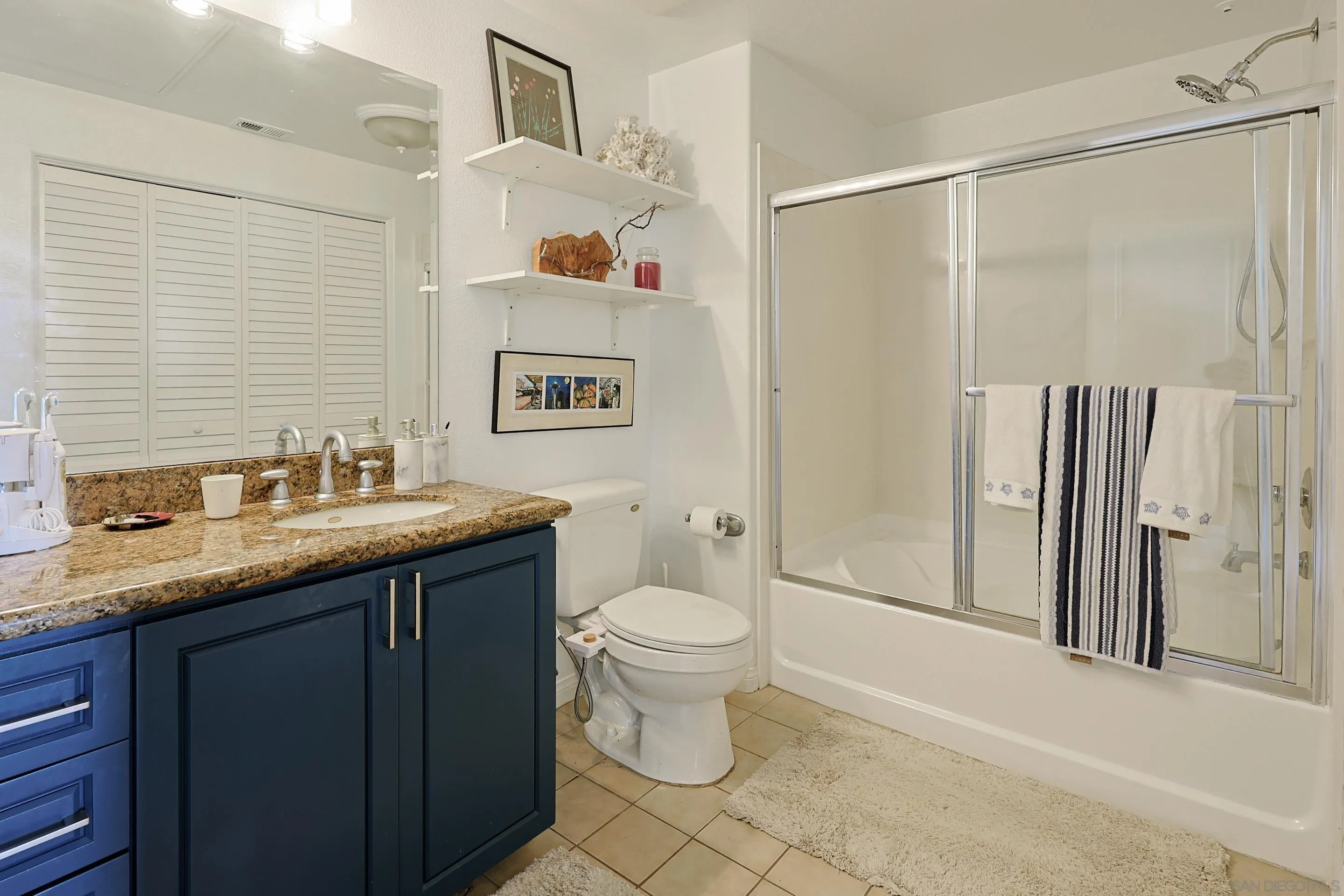 3887 Pell Place, Unit 229 San Diego, CA 92130 - Photo 15 of 49 a bathroom with a granite countertop sink toilet and shower
