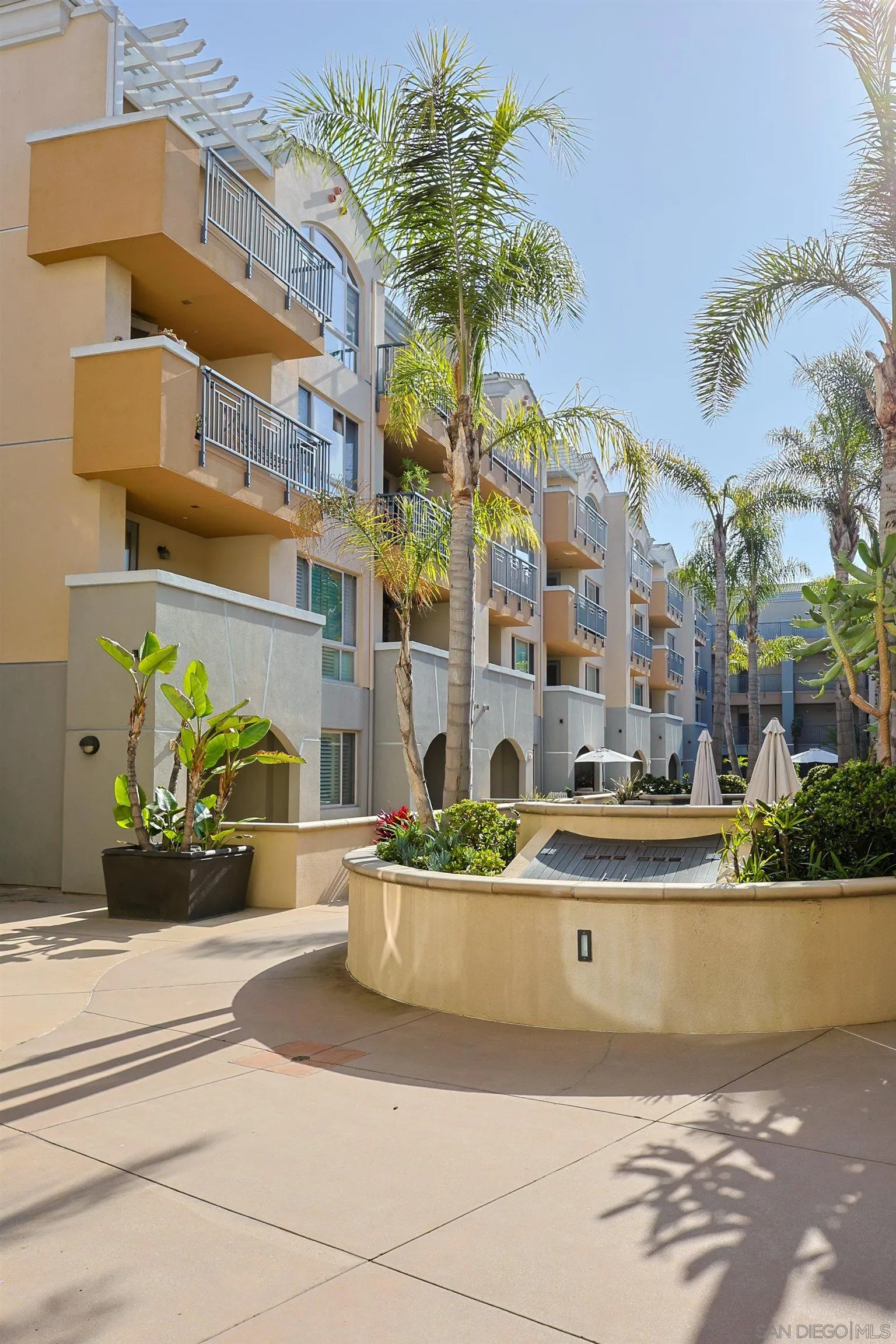 3887 Pell Place, Unit 229 San Diego, CA 92130 - Photo 44 of 49 a front view of a multi story residential apartment building with yard