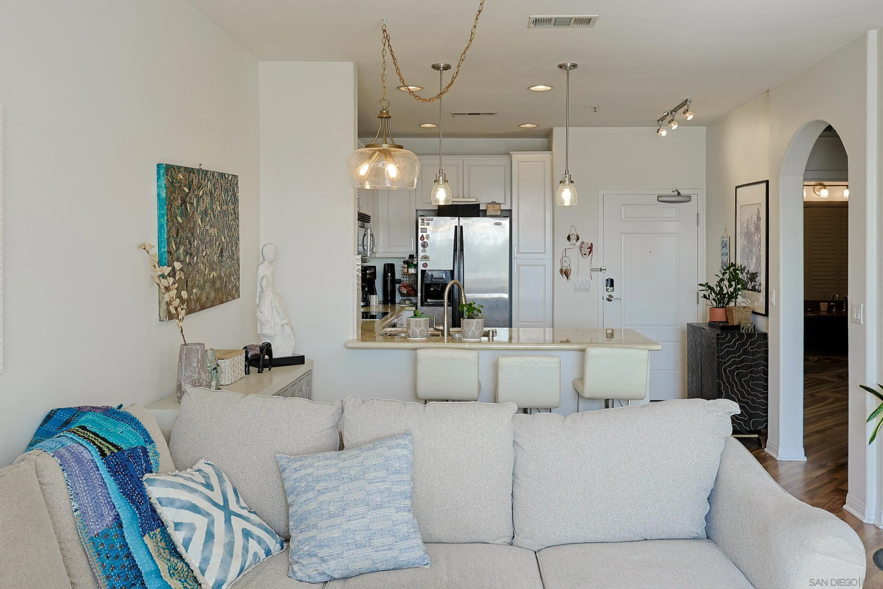 3887 Pell Place, Unit 229 San Diego, CA 92130 - Photo 5 of 49 a living room with furniture and a chandelier