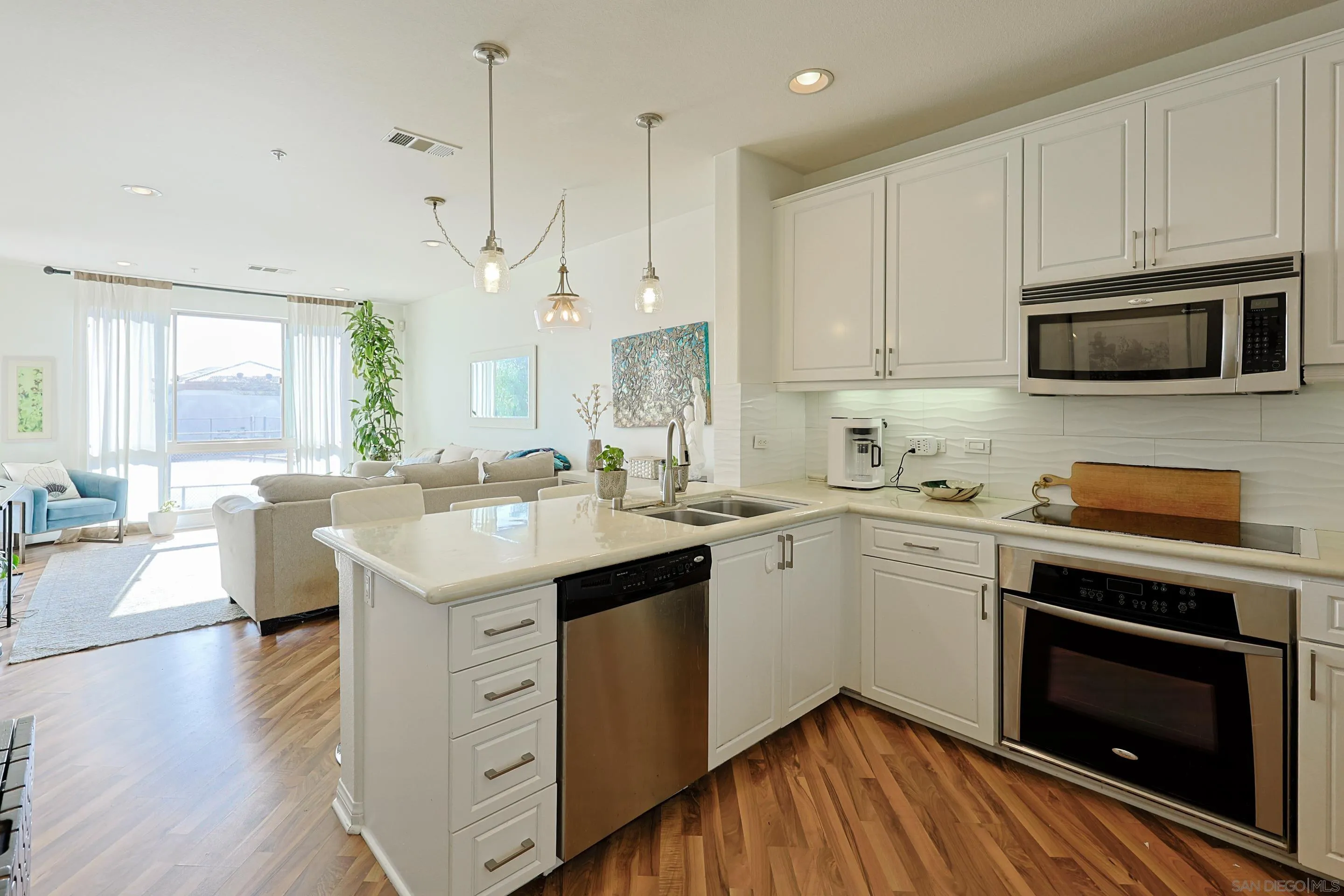 3887 Pell Place, Unit 229 San Diego, CA 92130 - Photo 9 of 49 a kitchen with a sink stove and microwave
