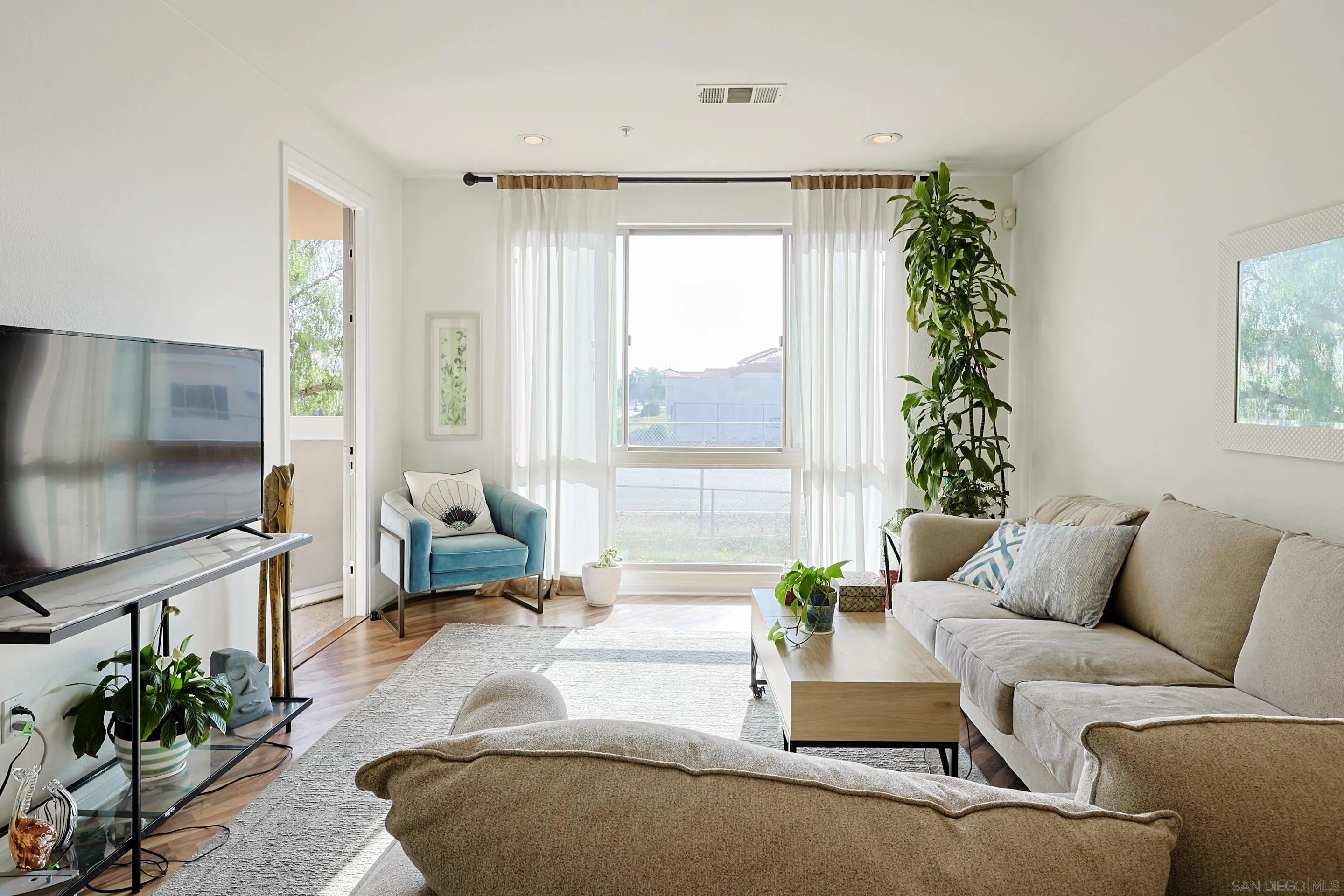 3887 Pell Place, Unit 229 San Diego, CA 92130 - Photo 10 of 49 a living room with furniture and a flat screen tv