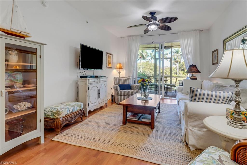 20140 Estero Gardens Circle, Unit 101 Estero, FL 33928 - Photo 12 of 40 a living room with furniture and a flat screen tv