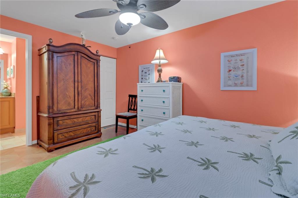 20140 Estero Gardens Circle, Unit 101 Estero, FL 33928 - Photo 18 of 40 a bedroom with a bed and a dresser