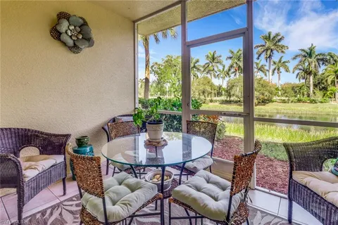 a dining room with furniture a rug and a potted plant