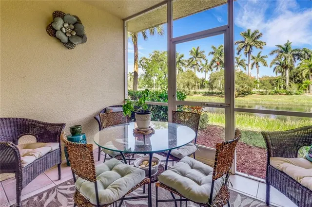 a dining room with furniture a rug and a potted plant