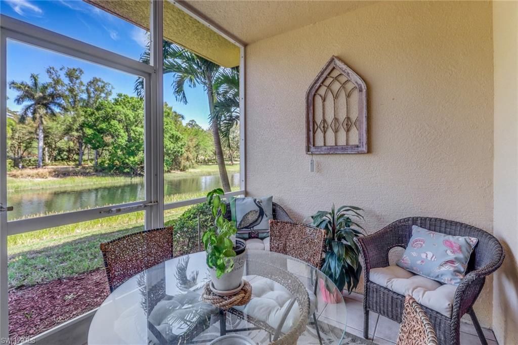 20140 Estero Gardens Circle, Unit 101 Estero, FL 33928 - Photo 22 of 40 a view of a porch with furniture and garden