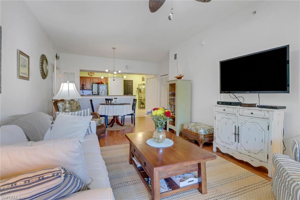 20140 Estero Gardens Circle, Unit 101 Estero, FL 33928 - Photo 8 of 40 a living room with furniture and a flat screen tv