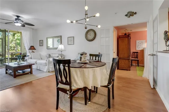 a living room with dining table furniture and a large window