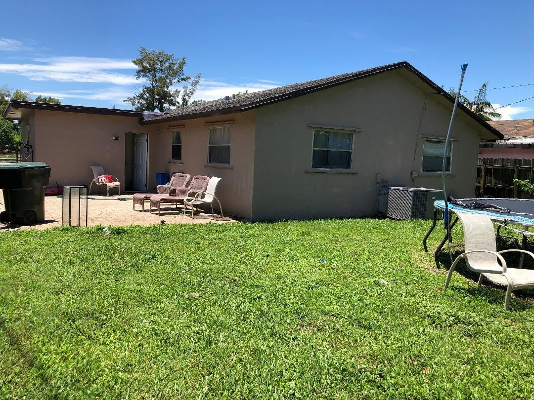 Undisclosed Address Boca Raton, FL 33487 - Photo 14 of 15 a backyard of a house with table and chairs