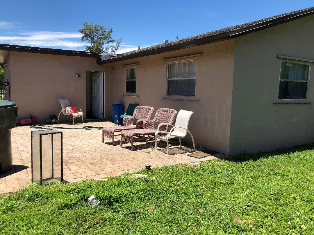 Undisclosed Address Boca Raton, FL 33487 - Photo 15 of 15 a view of a patio with table and chairs and potted plants