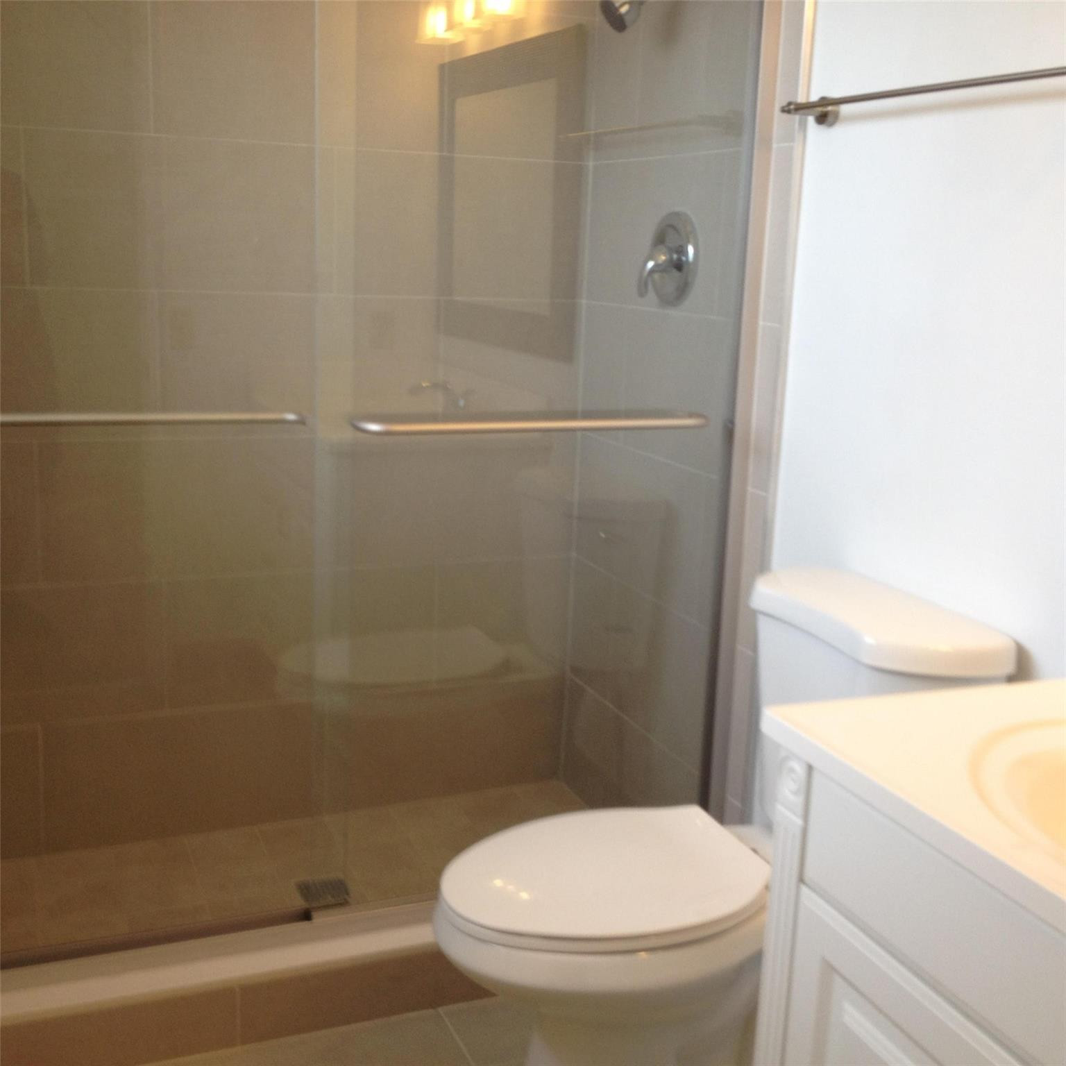 Undisclosed Address Boca Raton, FL 33487 - Photo 5 of 15 a white toilet sitting next to a bath tub