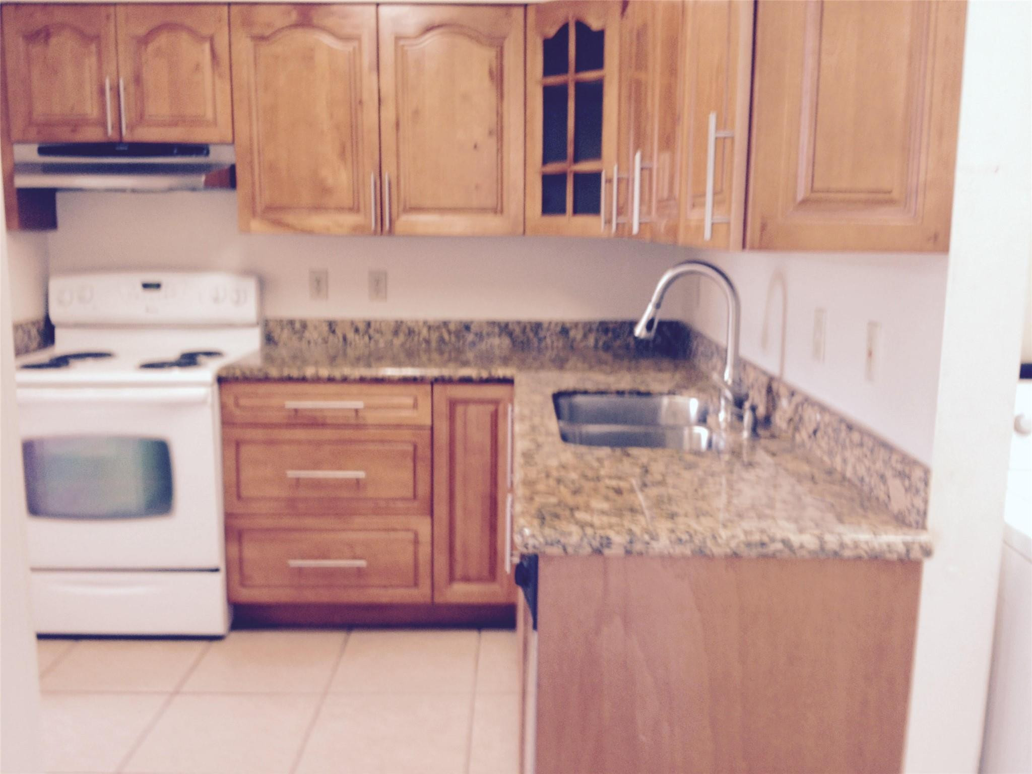 Undisclosed Address Boca Raton, FL 33487 - Photo 10 of 15 a kitchen with a stove and cabinets