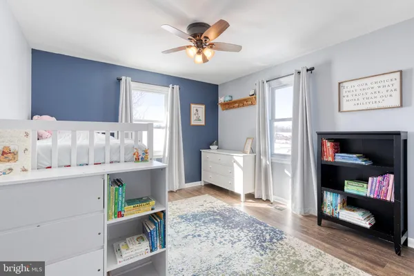 a living room with stainless steel appliances kitchen island a table and a window