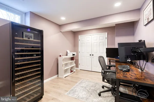 a view of a workspace with furniture and a window