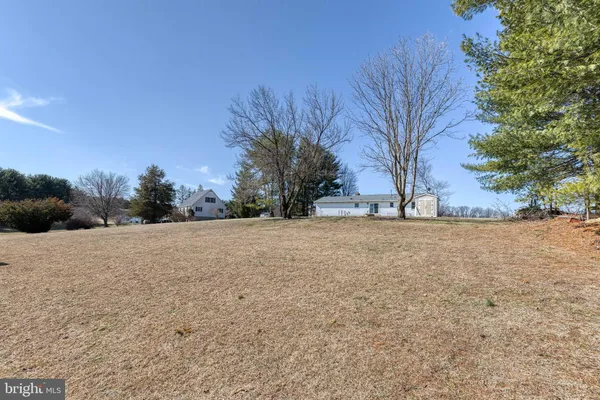 a view of outdoor space with trees in the background