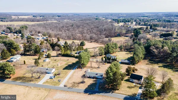 a view of a lake with a table and chairs