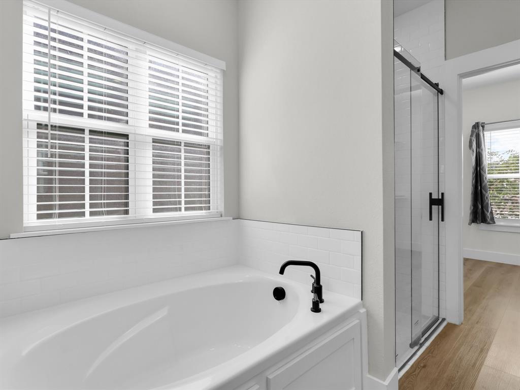 4905 Sweetbay Road Sherman, TX 75092 - Photo 15 of 26 a bathroom with a bathtub and window