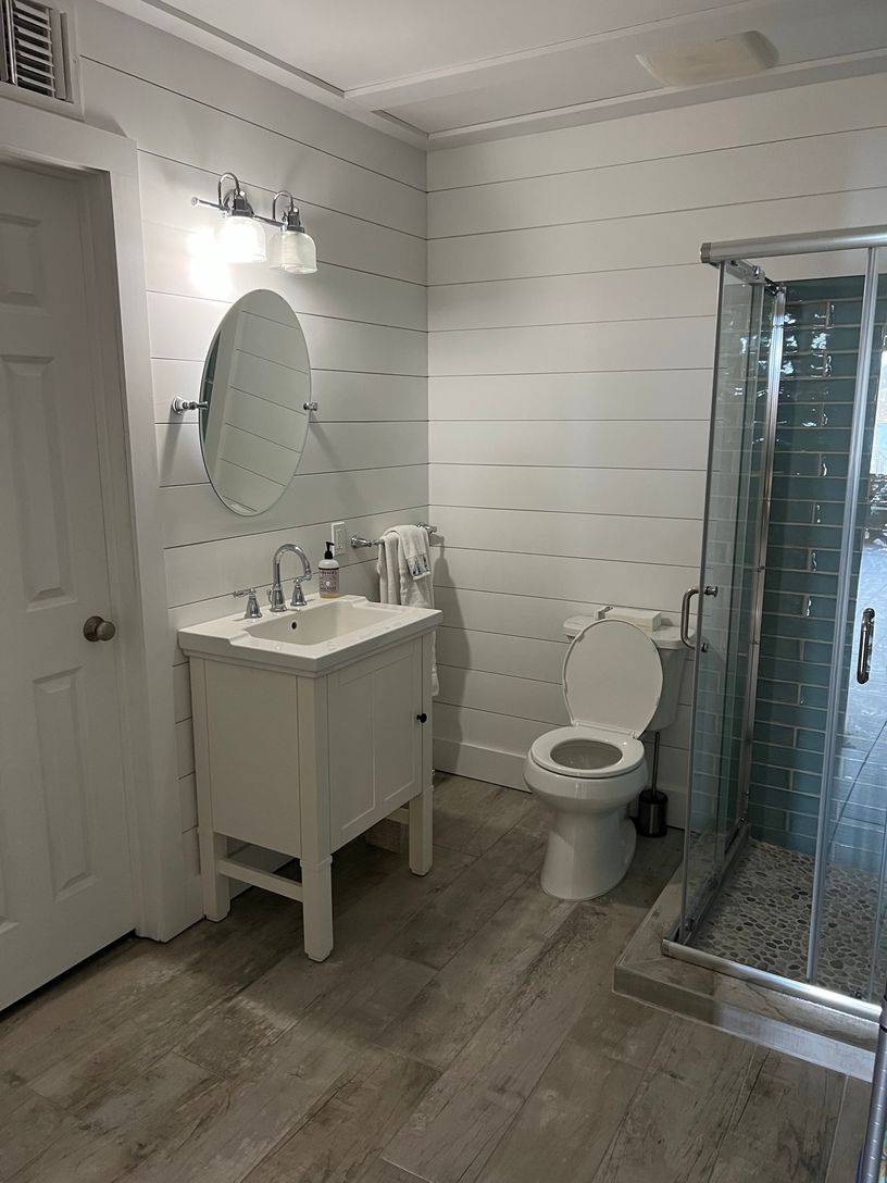 24 South Midway Road Shelter Island, NY 11964 - Photo 12 of 29 a spacious bathroom with a toilet sink and mirror