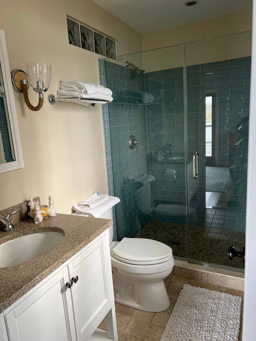 24 South Midway Road Shelter Island, NY 11964 - Photo 18 of 29 a bathroom with a granite countertop sink a toilet and shower