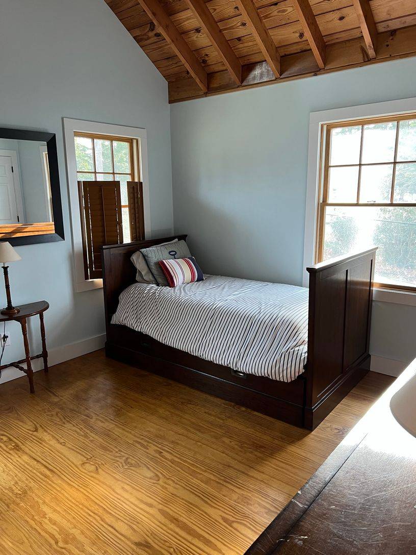 24 South Midway Road Shelter Island, NY 11964 - Photo 20 of 29 a bedroom with a bed a mirror and a window
