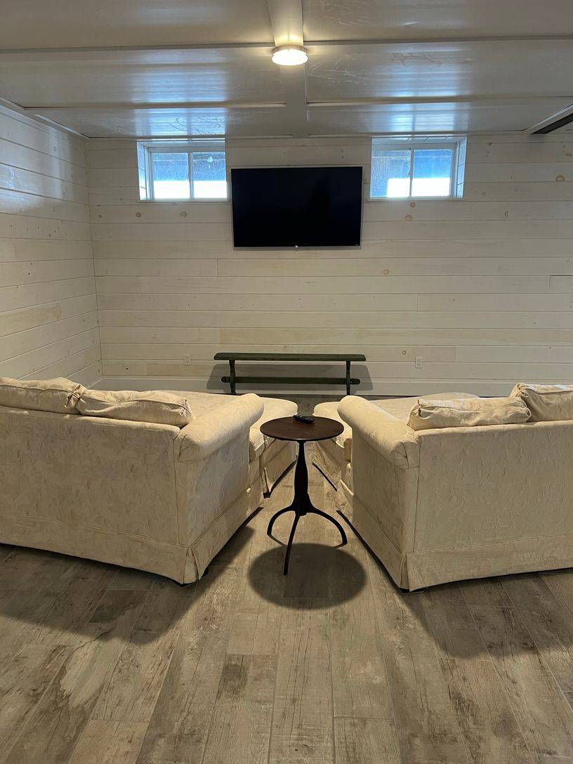 24 South Midway Road Shelter Island, NY 11964 - Photo 24 of 29 a living room with a couch and a flat screen tv