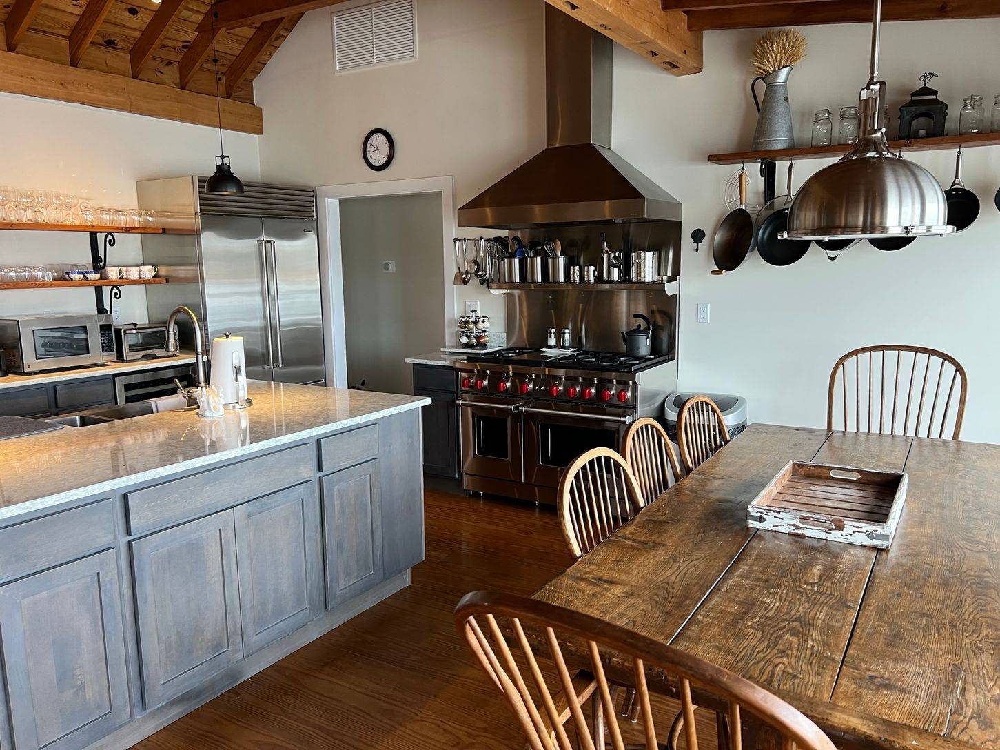 24 South Midway Road Shelter Island, NY 11964 - Photo 5 of 29 a kitchen with stainless steel appliances granite countertop a sink a stove and a wooden cabinets