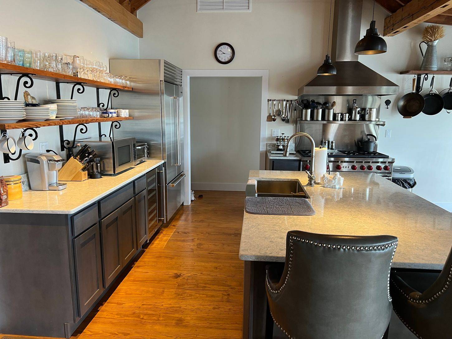 24 South Midway Road Shelter Island, NY 11964 - Photo 6 of 29 a kitchen with stainless steel appliances granite countertop a sink and white cabinets