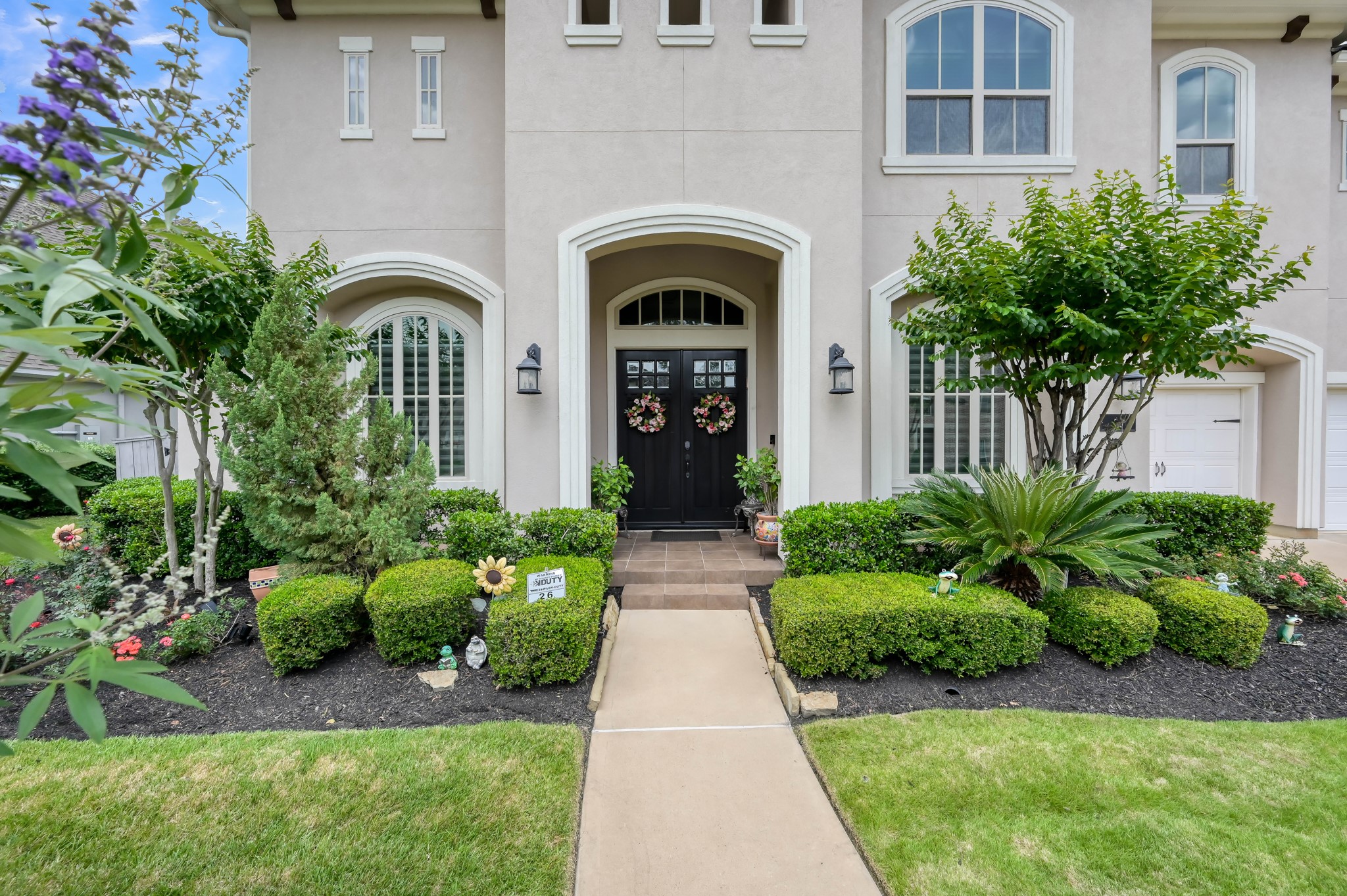 26 Woodborough Way Spring, TX 77389 - Photo 2 of 43 Discover this elegant home in Liberty Branch, Creekside, showcasing a stunning stucco elevation and grand double doors.
