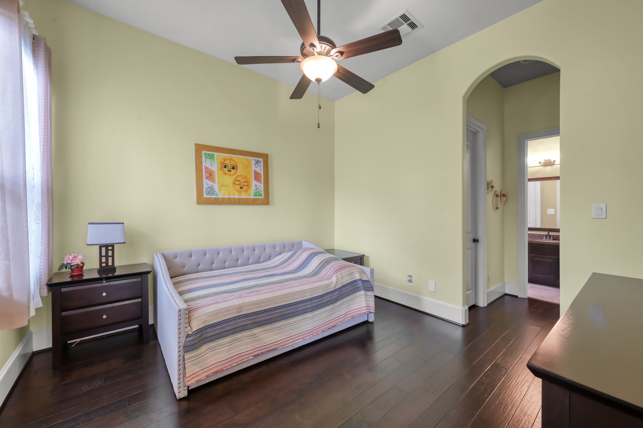 26 Woodborough Way Spring, TX 77389 - Photo 23 of 43 Discover the inviting charm of this downstairs bedroom featuring sleek hardwood floors, abundant natural light, and convenient access to a full bath for ultimate comfort and ease.
