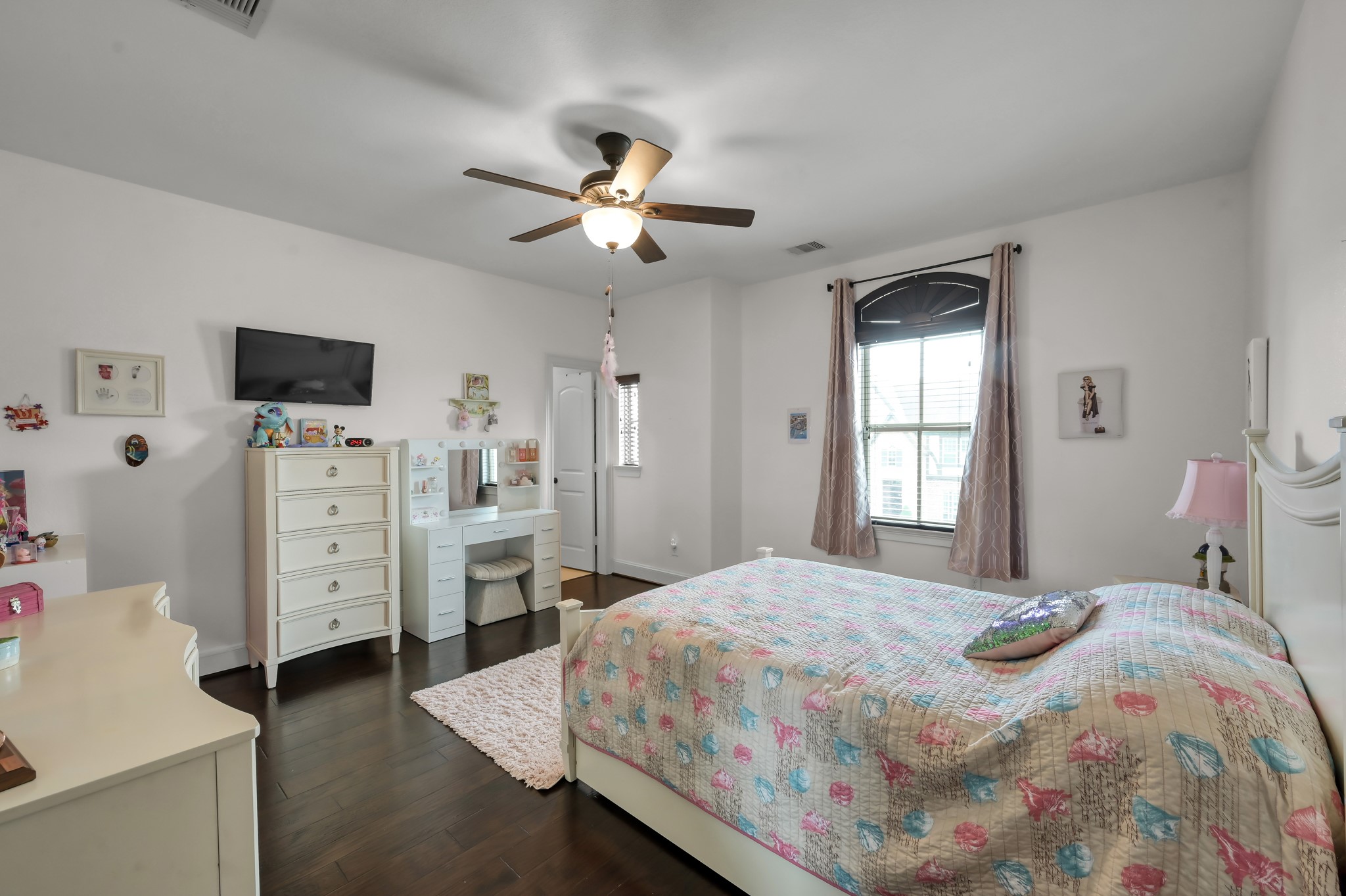 26 Woodborough Way Spring, TX 77389 - Photo 29 of 43 Cozy bedroom with a ceiling fan, hardwood floors, and ample natural light. Note that the upstairs features no carpeting.