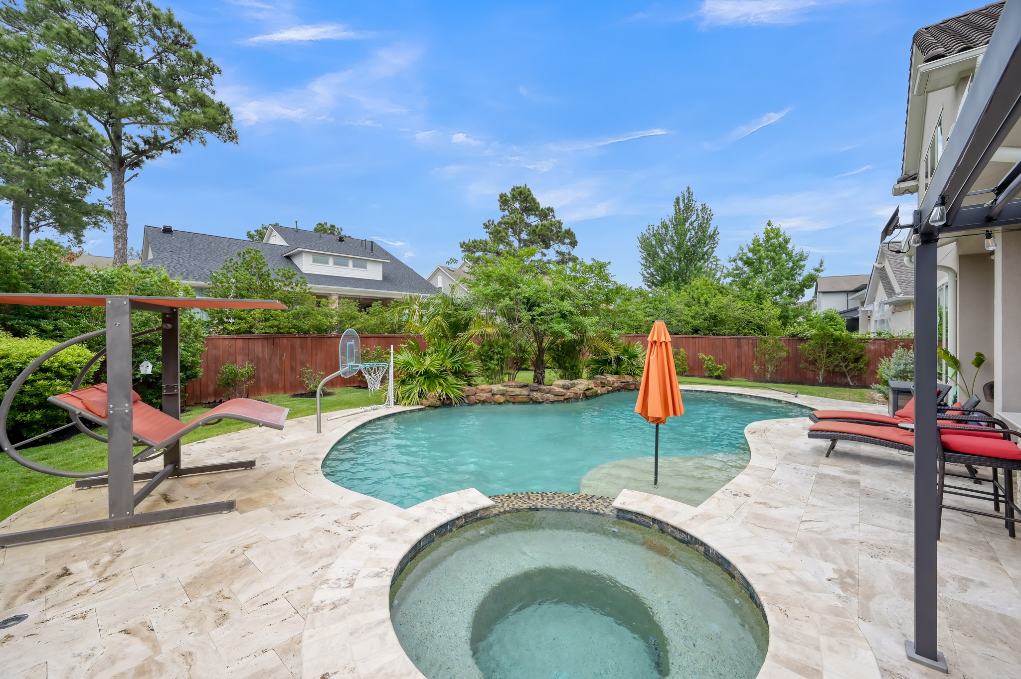 26 Woodborough Way Spring, TX 77389 - Photo 39 of 43 This backyard oasis features a stunning pool with a built-in spa, surrounded by lush landscaping and a privacy fence.