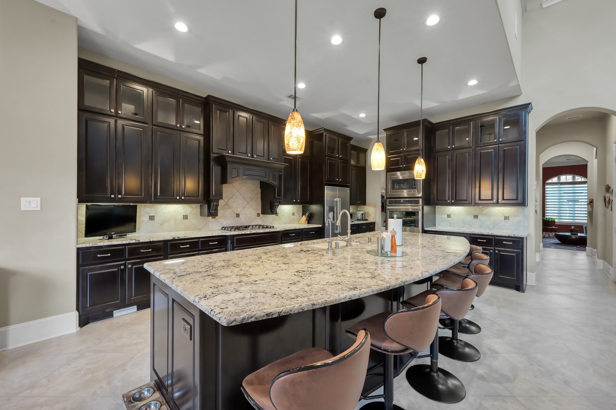 26 Woodborough Way Spring, TX 77389 - Photo 6 of 43 Discover a spacious kitchen with elegant double-decker cabinets, sleek granite countertops, and convenient double ovens—perfect for culinary enthusiasts.