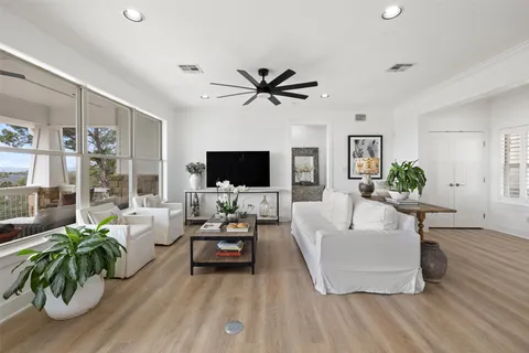 a living room with kitchen island furniture and a wooden floor