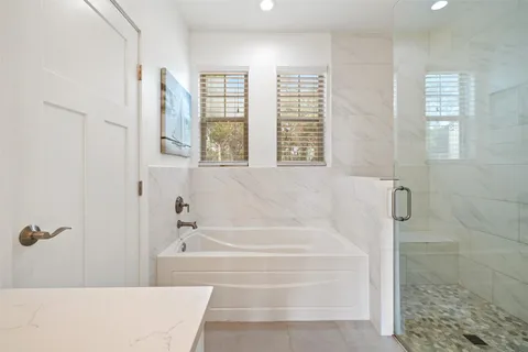 a white bath tub sitting next to a window