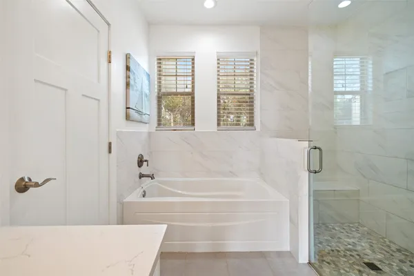 a white bath tub sitting next to a window