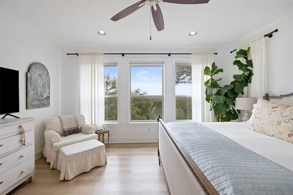 a spacious bedroom with a large bed and a couch
