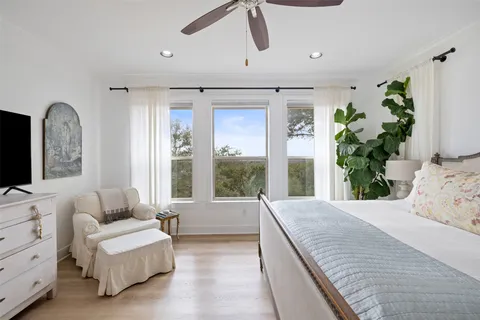 a bedroom with two beds and a chandelier