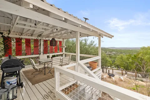a view of a patio with table and chairs and wooden floor