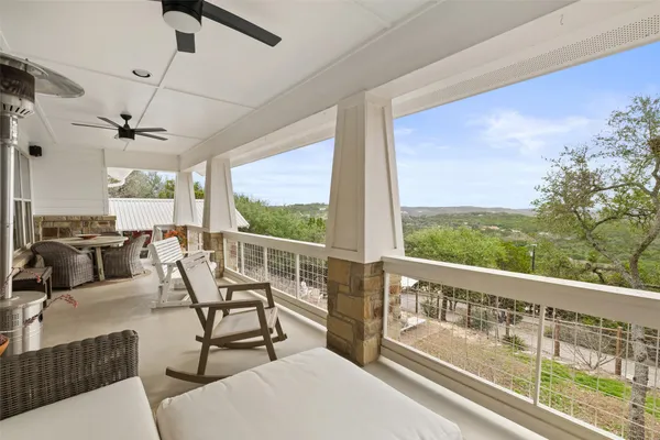 a view of a chairs and table in the balcony
