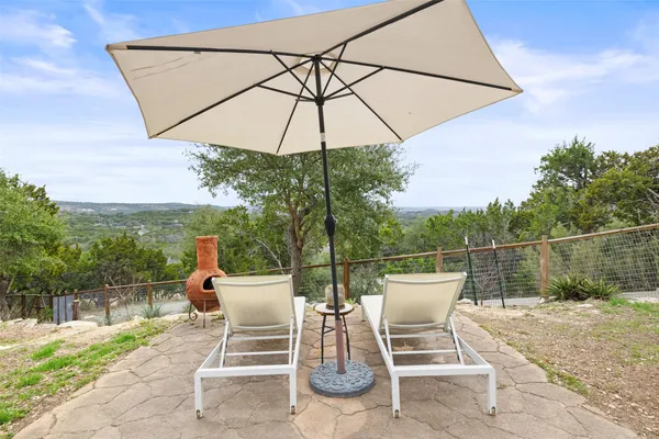 a view of a chairs and table in the patio