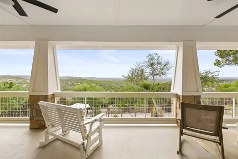 a view of a chairs and table in a balcony