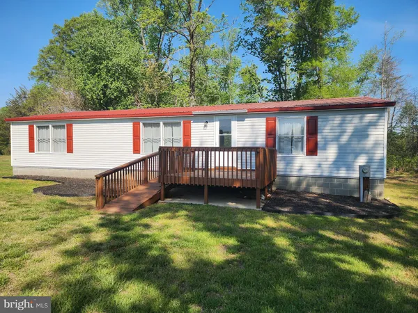a backyard of a house with garden and deck