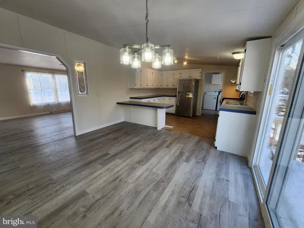 a kitchen with stainless steel appliances granite countertop wooden floors and stove