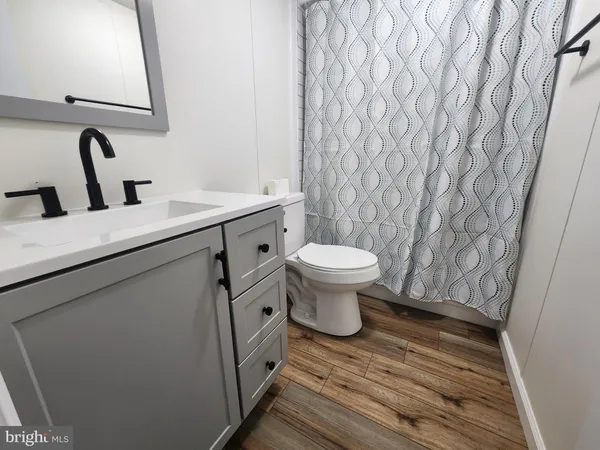 a bathroom with a sink toilet a mirror and vanity