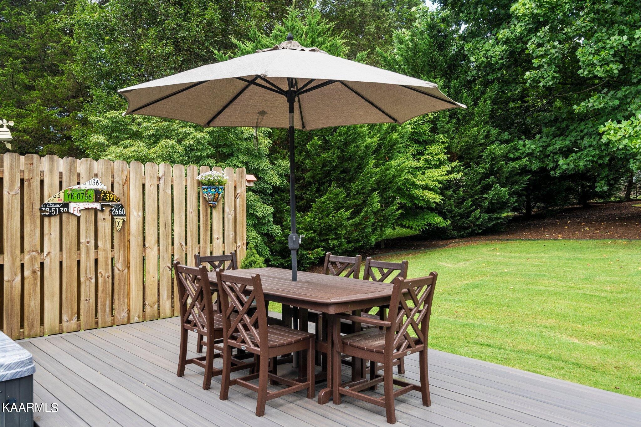 1309 Ridgeway Circle Athens, TN 37303 - Photo 35 of 48 a patio with wooden floor a yard a table and chairs