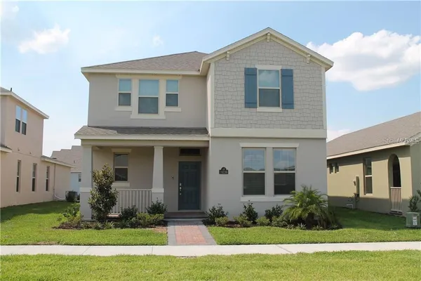 a front view of house with yard and green space