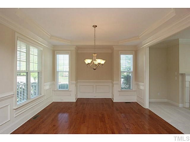 4701 All Points View Way Raleigh, NC 27614 - Photo 5 of 20 Formal dining room with wainscoting, detailed moldings, trey ceiling, hardwood flooring, multiple windows provide plenty of natural light. Opens to family room...perfect when entertaining family & friends. Formal Dining Room